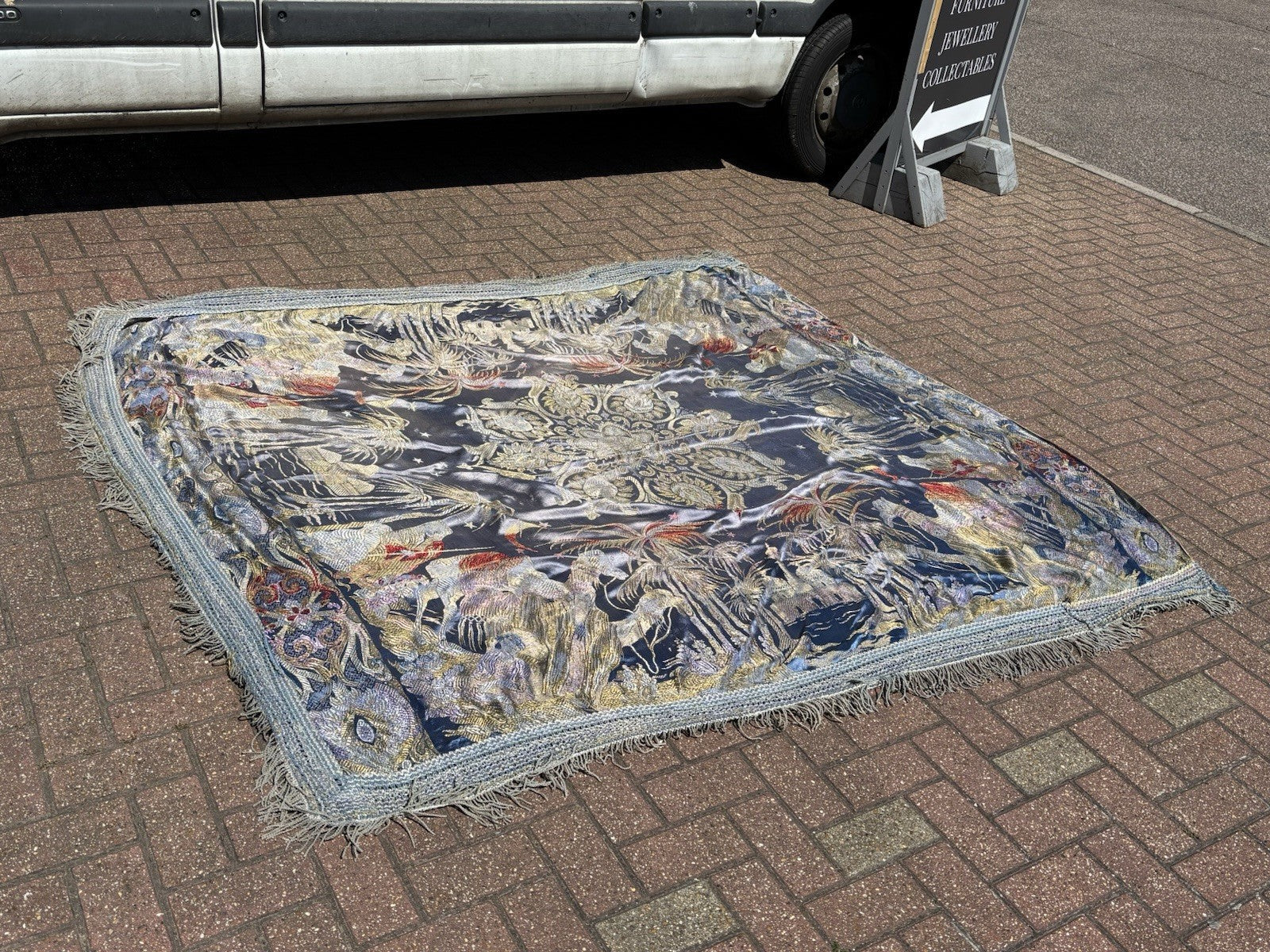 An early 20th Century large silk bed spread decorated with Middle Eastern scenes