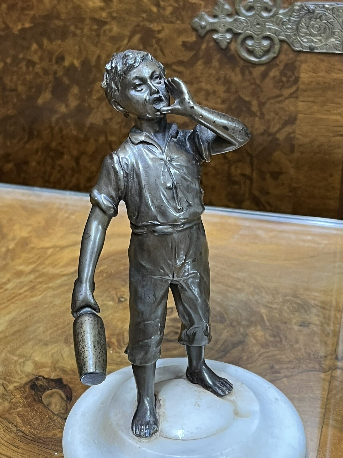 Art Deco figure on white marble base.