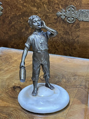 Art Deco figure on white marble base.