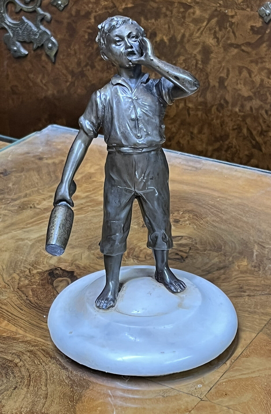 Art Deco figure on white marble base.
