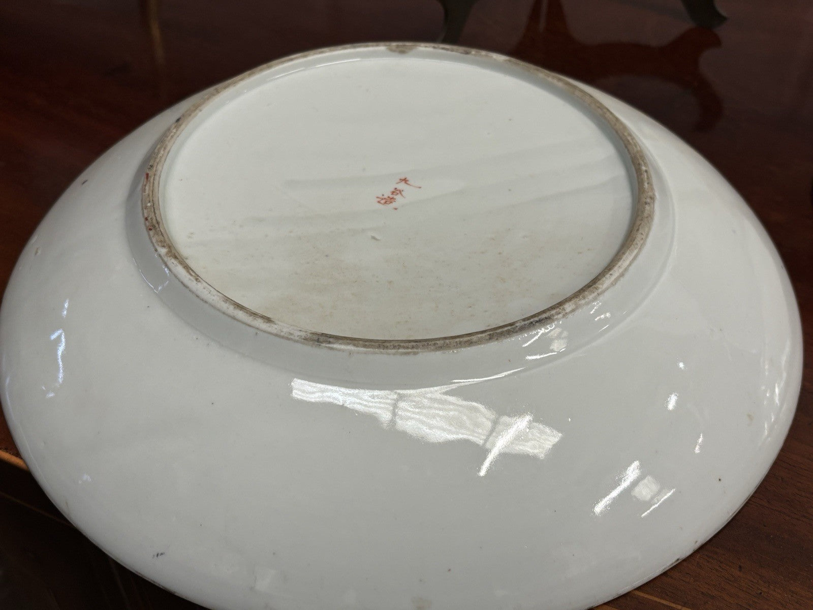 A Japanese Kutani charger signed Meiji period With A Smaller Plate