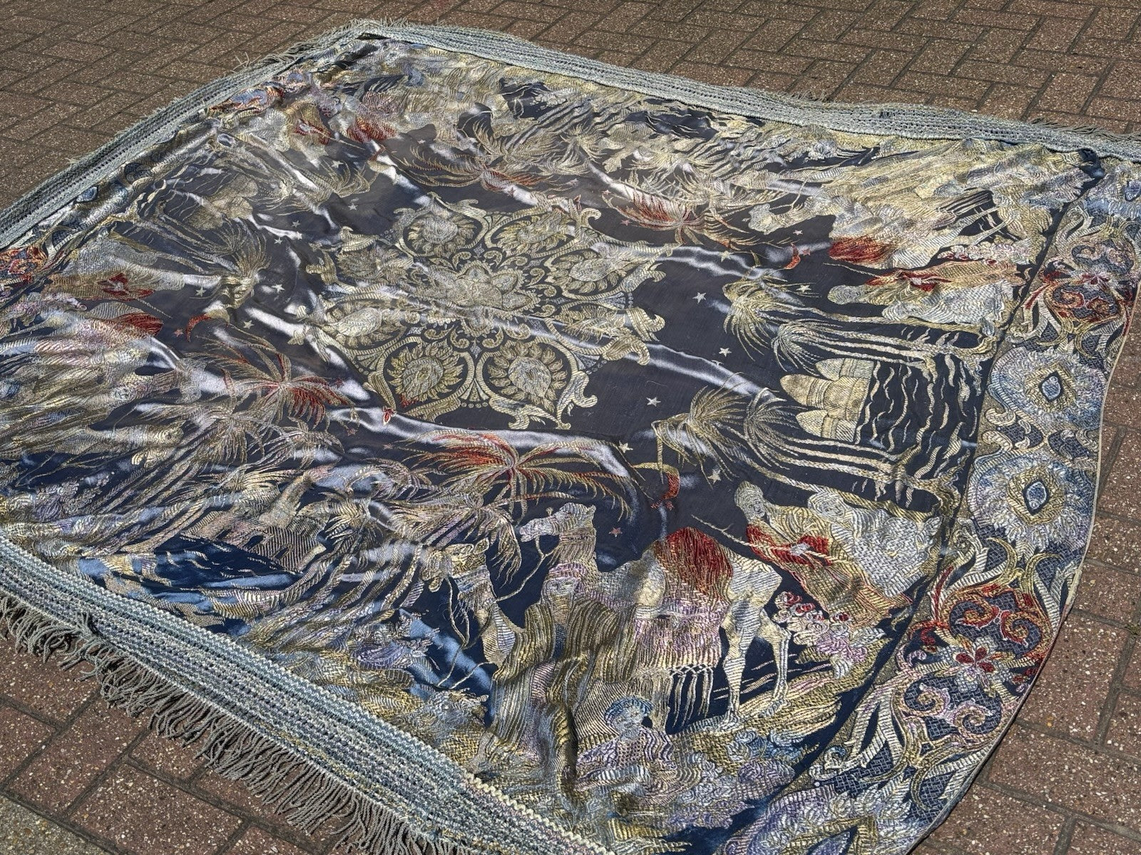 An early 20th Century large silk bed spread decorated with Middle Eastern scenes