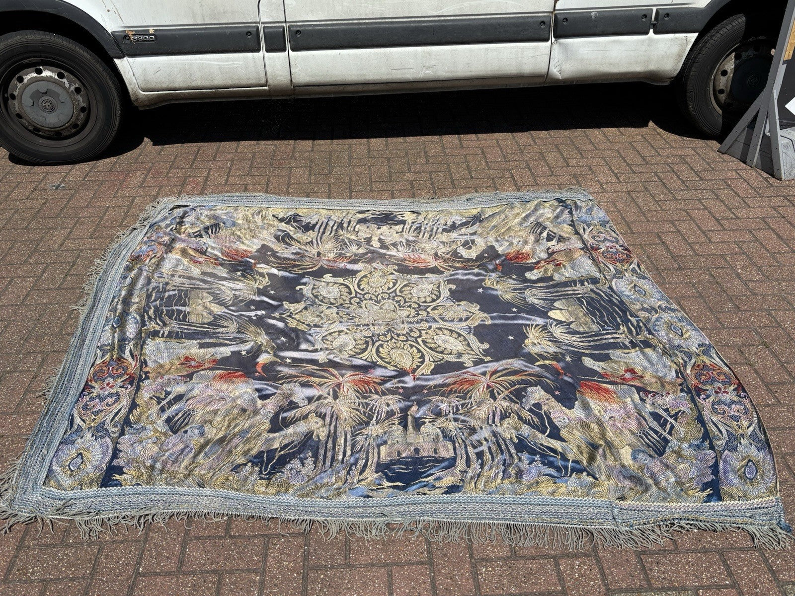 An early 20th Century large silk bed spread decorated with Middle Eastern scenes